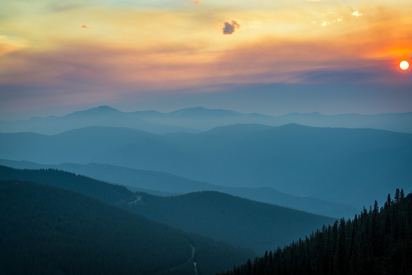 Ridges Fading to Blue — Mestaa'ehehe Mountain, Colorado. Range after range stacking into the haze at sunset from Mestaa'Ehehe Mountain, each one a shade…