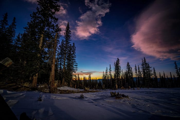 Stars Twenty Minutes Out — Mestaa'ehehe Mountain, Colorado. The last pink cloud of the day drifting over snow-loaded pines with the blue of night already…