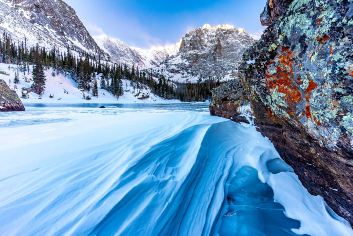 Frozen Surf — Rocky Mountain National Park, Colorado. Wind carving the snow on The Loch into what looks exactly like frozen surf, blue drifts curling across…