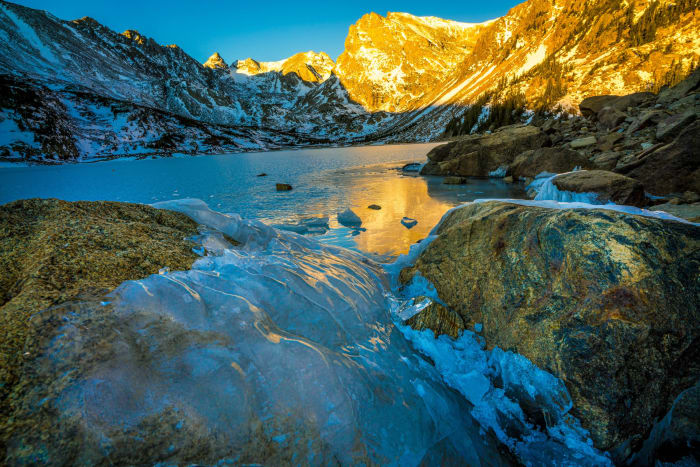 An Hour From the Shoreline — Indian Peaks Wilderness, Colorado. First light picking out the high ridge in blazing gold while the lake below stays locked in…