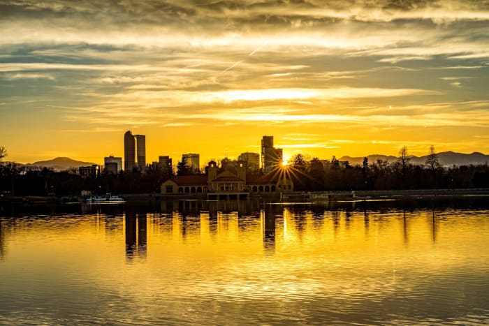 Straight Behind Downtown — City Park, Denver. The sun dropping straight behind the Denver skyline from across Ferril Lake in City Park, turning the whole…