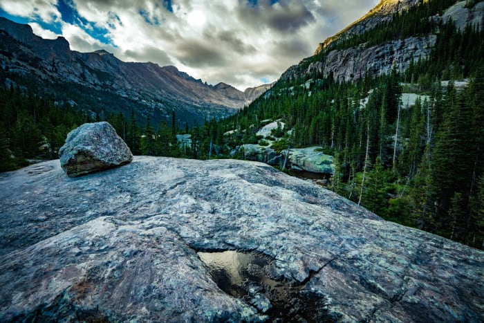Where the Ice Left It — Rocky Mountain National Park, Colorado. A glacial erratic parked on polished granite exactly where the ice dropped it, with Glacier…