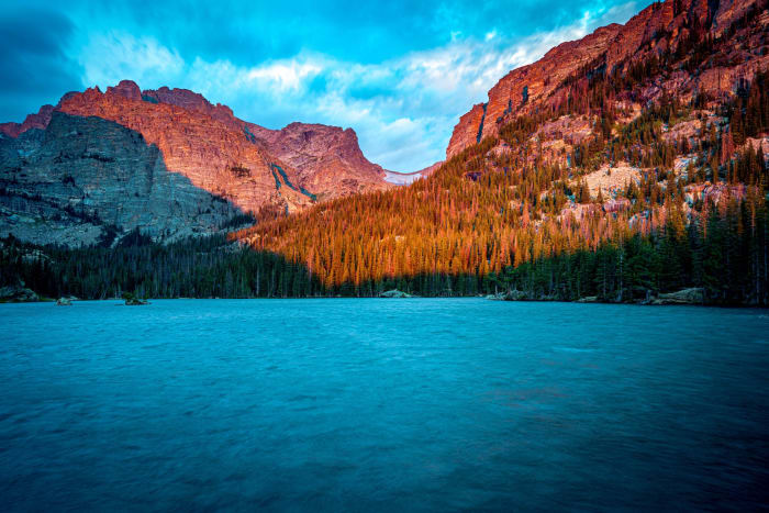 The Loch Warms Up — Rocky Mountain National Park, Colorado. First light working its way down the walls above The Loch in Rocky Mountain National Park,…