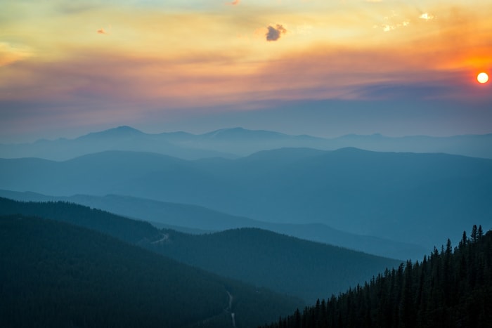 Ridges Fading to Blue — Mestaa'ehehe Mountain, Colorado. Range after range stacking into the haze at sunset from Mestaa'Ehehe Mountain, each one a shade…