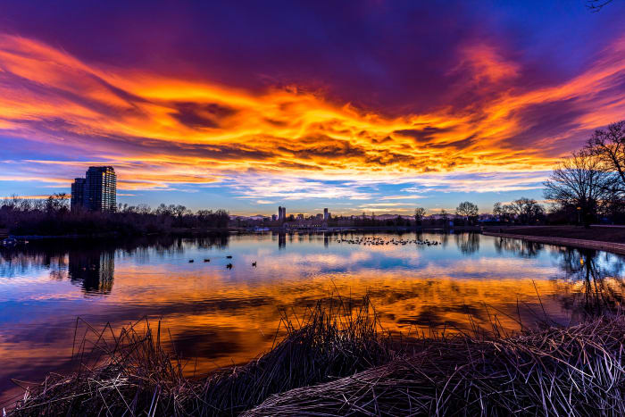 City Park Under a Burning Sky — City Park, Denver. A blazing sunset over Ferril Lake in Denver's City Park, Colorado, with fiery orange and purple clouds…