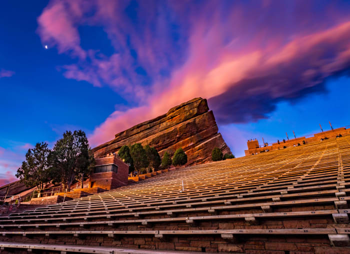 A Morning Show at Red Rocks — Red Rocks Park, Morrison. Sunrise at Red Rocks Amphitheatre near Morrison, Colorado, with pink and violet clouds streaking…