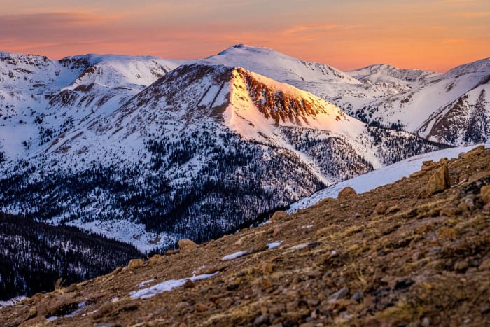 The Day Ends in Stages — Loveland Pass, Colorado. Alpenglow finding the one ridge still catching sun while everything below has already gone cold and blue.