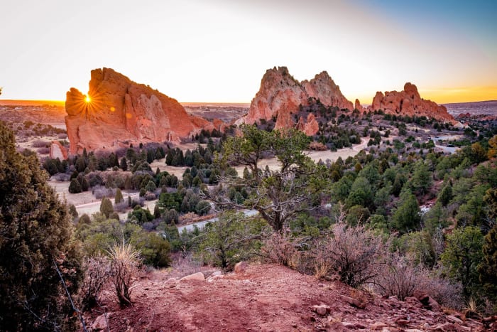 Sunburst Through the Fins — Garden of the Gods, Colorado Springs, Colorado. The sun cracking over the sandstone fins at Garden of the Gods and throwing a…