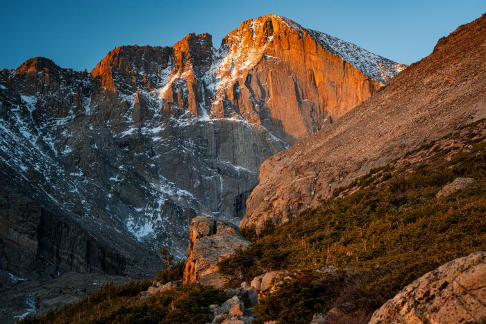 First Fire on the Diamond — Chasm Lake, Colorado. First light hitting the Diamond on Longs Peak and turning the whole east face copper while the talus and…