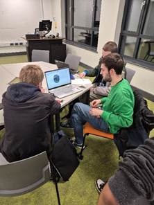 A group of people sitting at a desk
