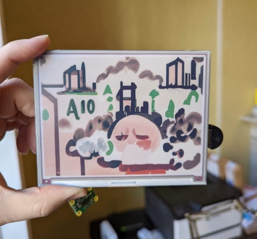 A prototype displaying an image generated from the phrase "the air quality is very poor" on a 7 colour eInk display