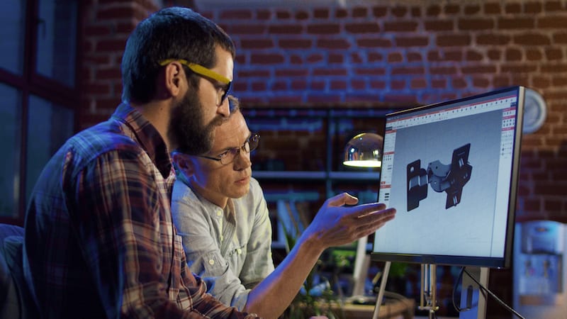 Design engineers looking at display