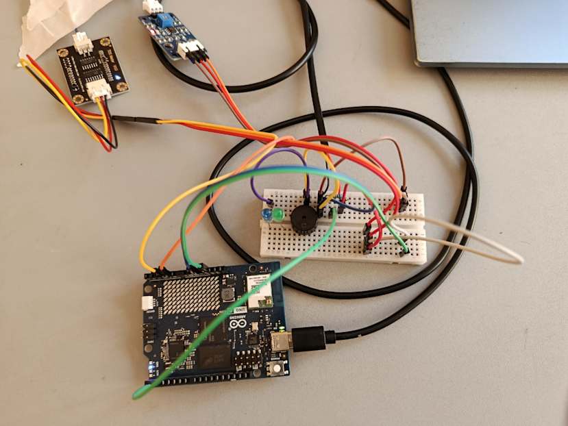 An Arduino UNO Q connected to a breadboard and sensors