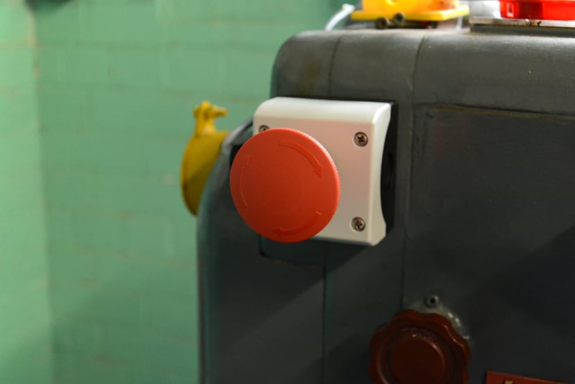 Emergency stop button mounted on lathe