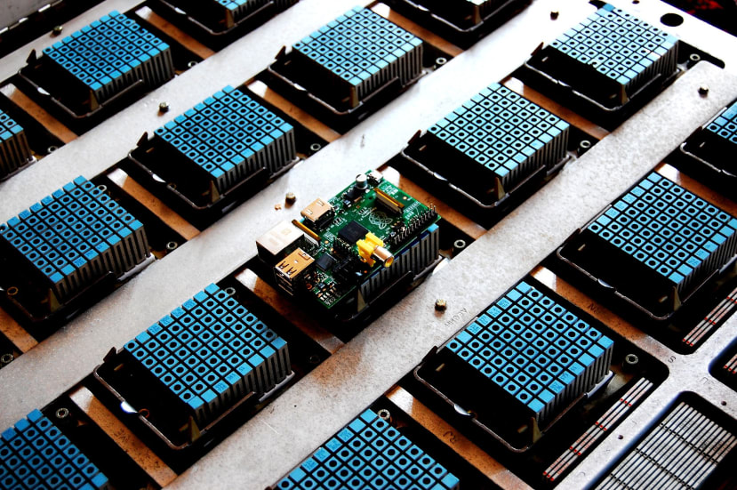 A Raspberry Pi 1 sat on top of an IBM 4381 processor multi-chip module