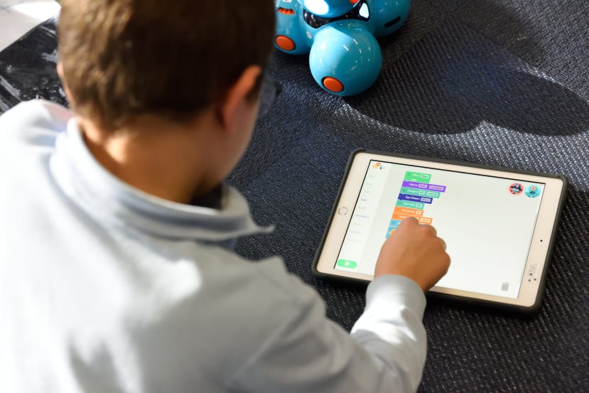Child learning to code on a pad