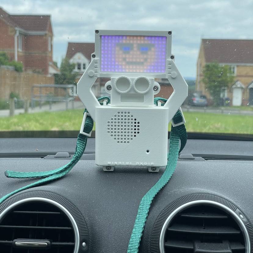 Mindful Droid sitting on a car dashboard