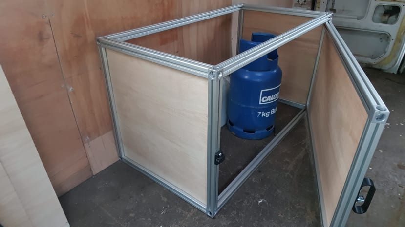 Gas bottle subframe with wooden cladding and door