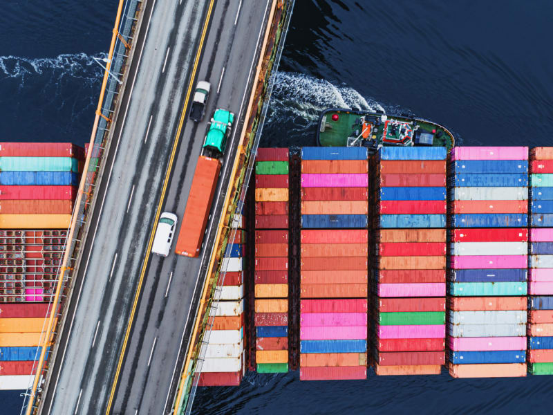 Container ship moving under the bridge