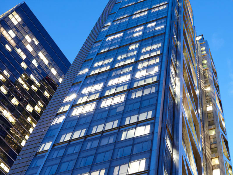The facade of an office building against the backdrop of the evening sky