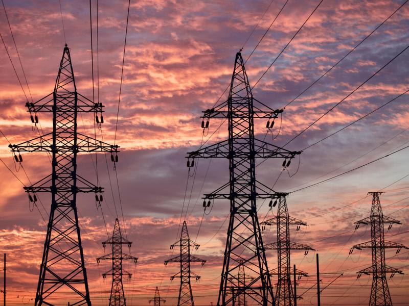 High voltage towers at sunset background