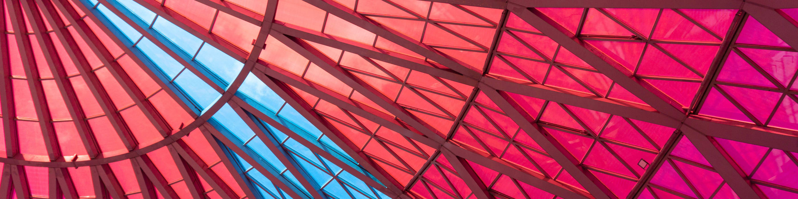Semitransparent red glass ceiling with clear blue sky stripe