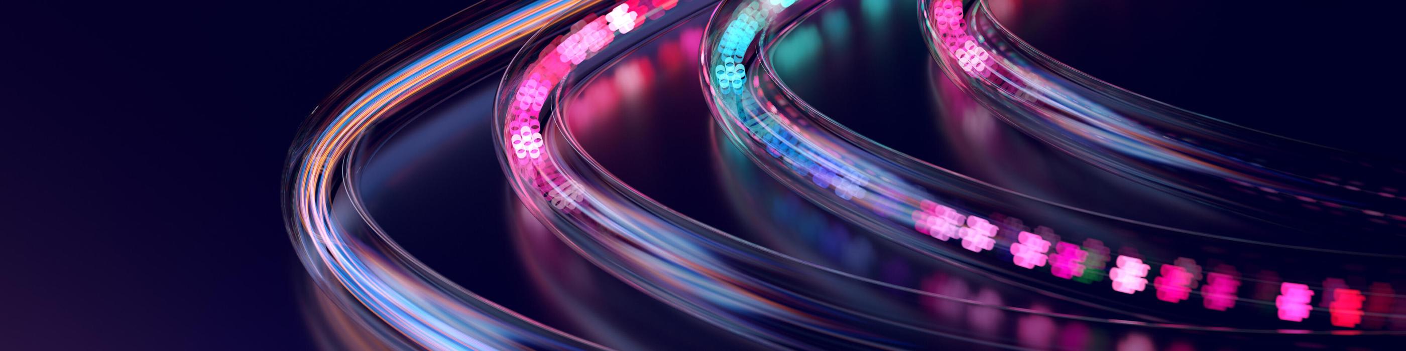 Abstract image of smooth, curved light trails in pink, blue, and purple tones forming a flowing path