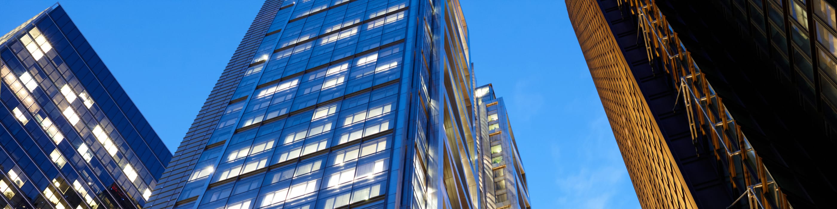 The facade of an office building against the backdrop of the evening sky
