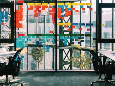 Workshop output, represented by sticky notes on an office window.