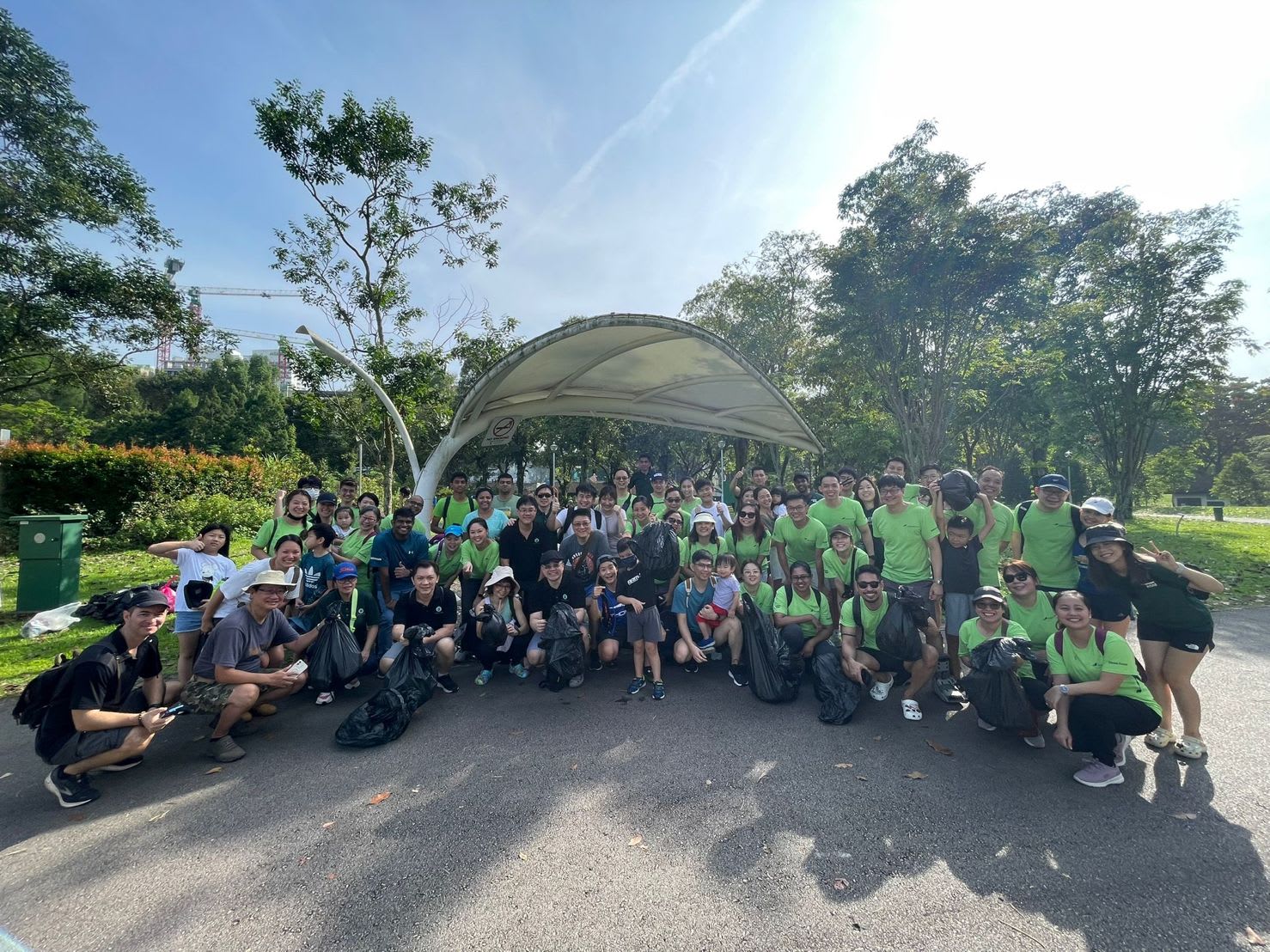 RSM Singapore employees taking a group photo in front of Bishan Park after the event with non-profit association (ISC)2 Singapore Chapter to clean up the park