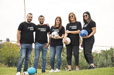 Kyphos playing mini-football with his friends