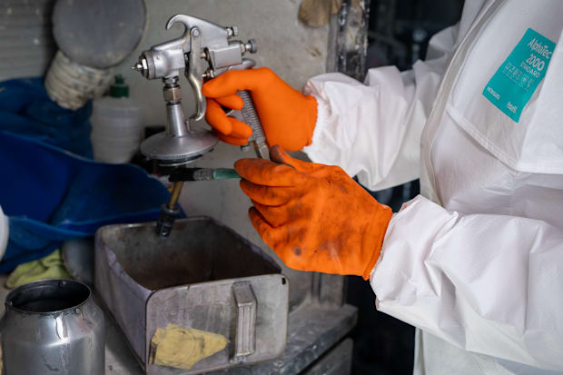 Image of a hand wearing orange gloves