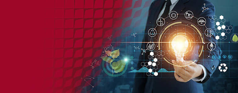 A person in a suit holds a glowing lightbulb with digital icons representing energy, sustainability, and technology.