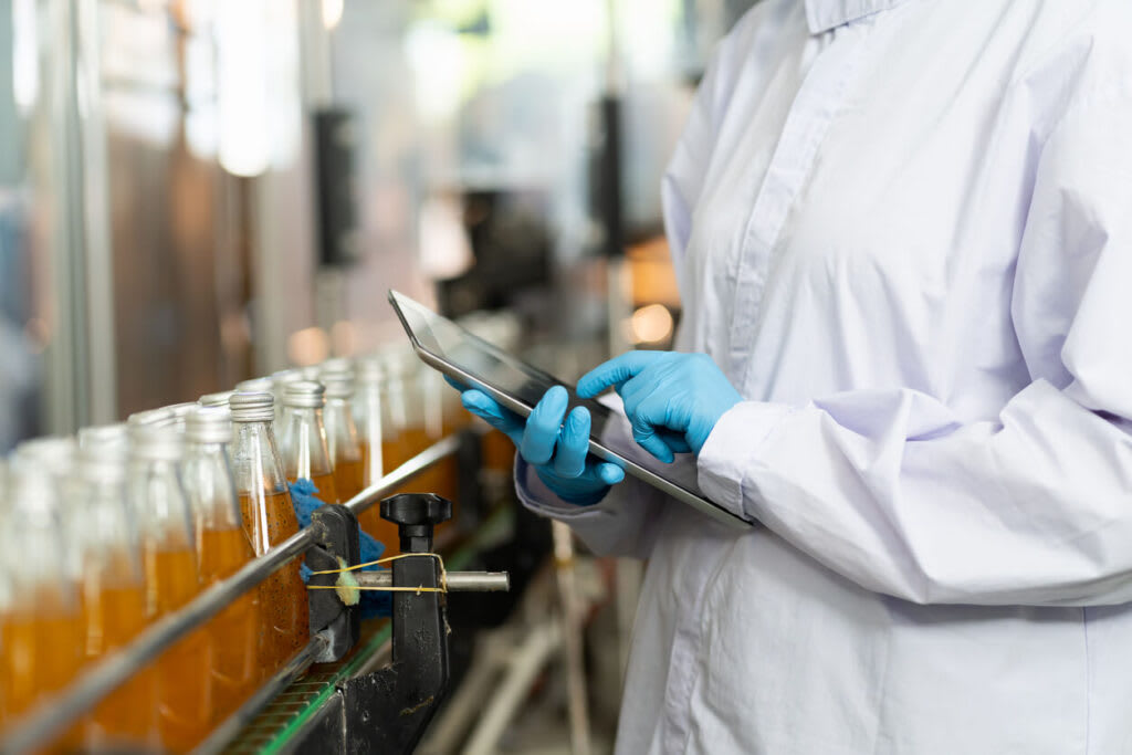 A factory worker quality controlling a product