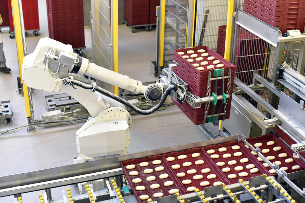Robotic arm moving product in factory