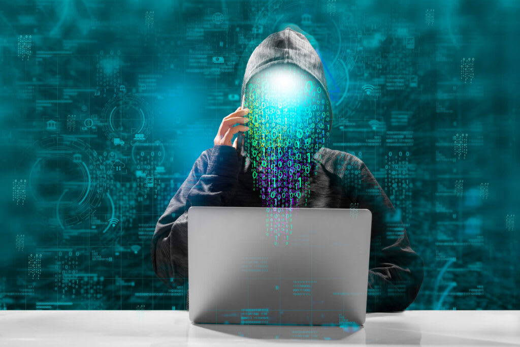 An image of a hacker on a laptop