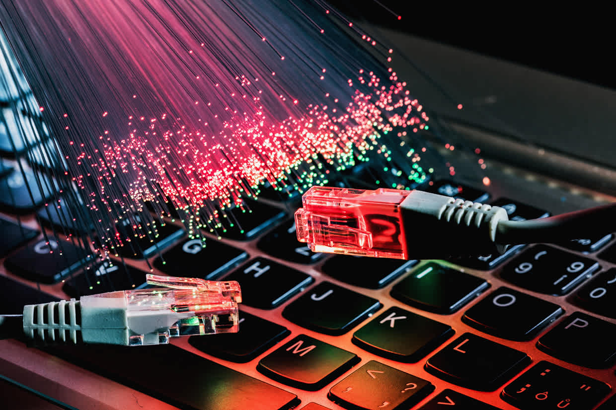 Ethernet cables on a laptop, representing network speed and connectivity when comparing Modbus TCP and Modbus RTU performance.