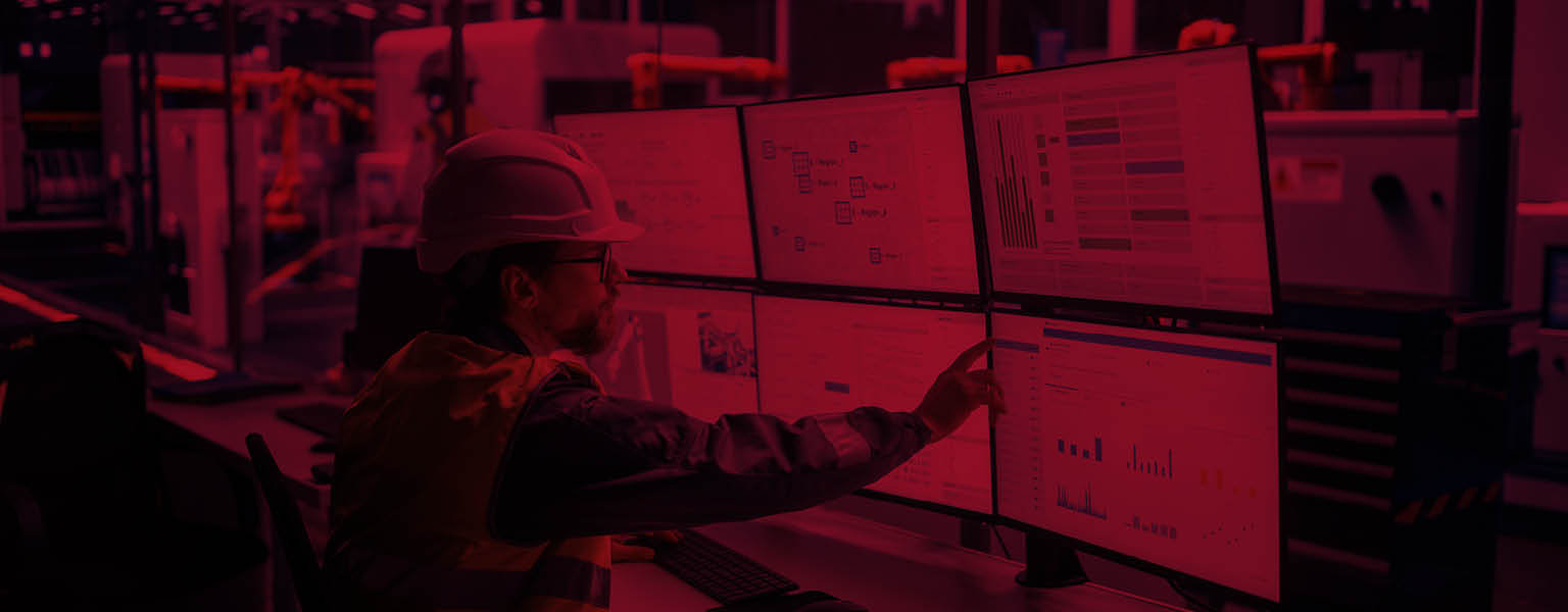 a worker in ppe at a desk conducting process monitoring
