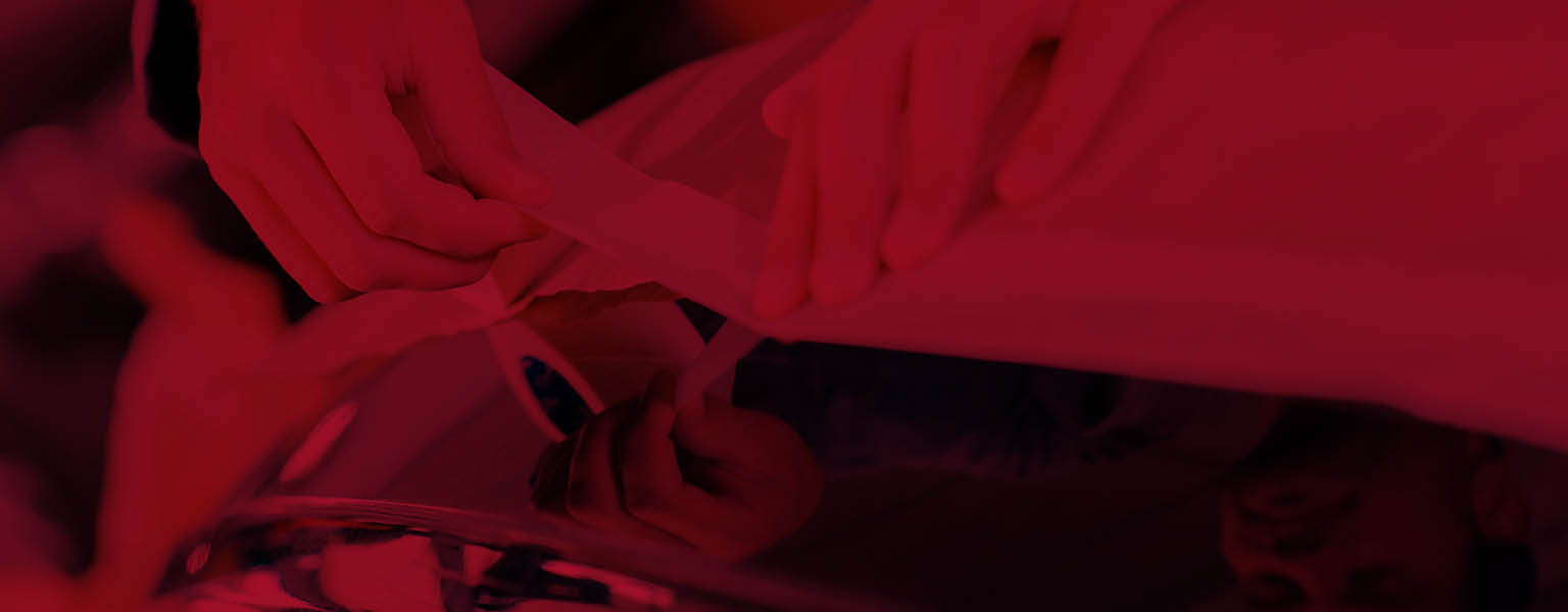 A person applying masking tape