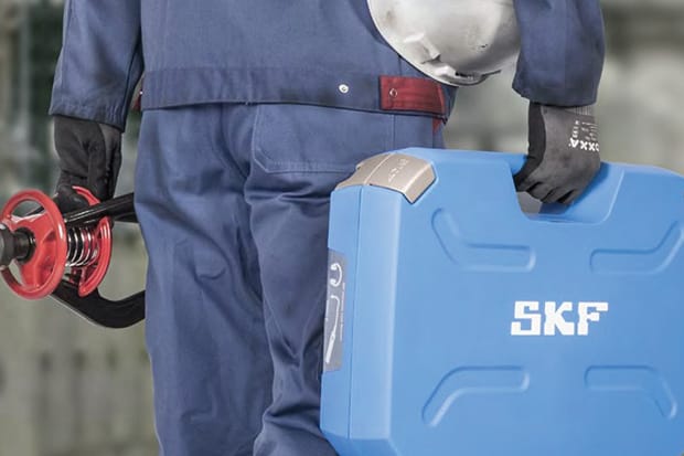 Engineer carrying parts and SKF instrument case