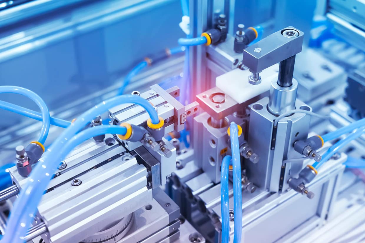 A pneumatic system with blue hoses and yellow nozzles attached to the machine.