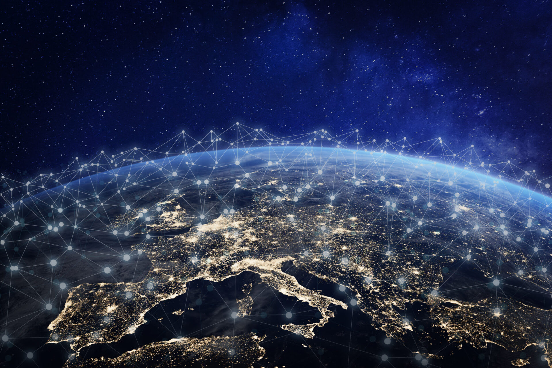 Satellite-style view of Earth at night focused on Europe, with illuminated cities and digital network connection lines representing global connectivity and communication technology.