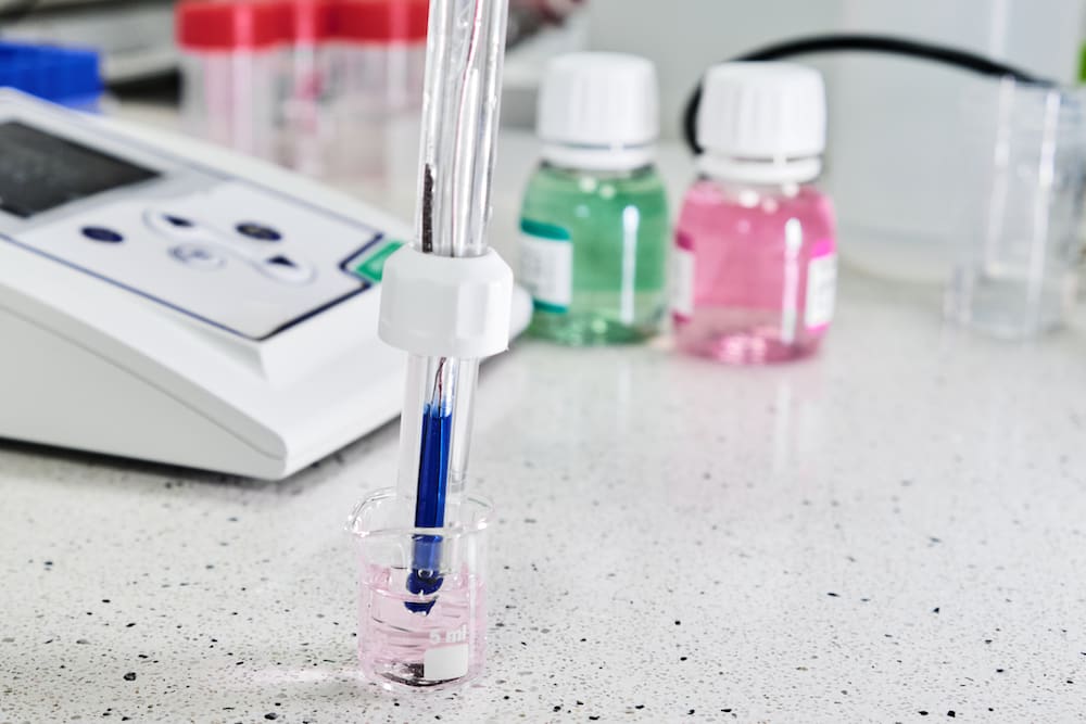 a pH meter with glass electrode in a calibration solution.