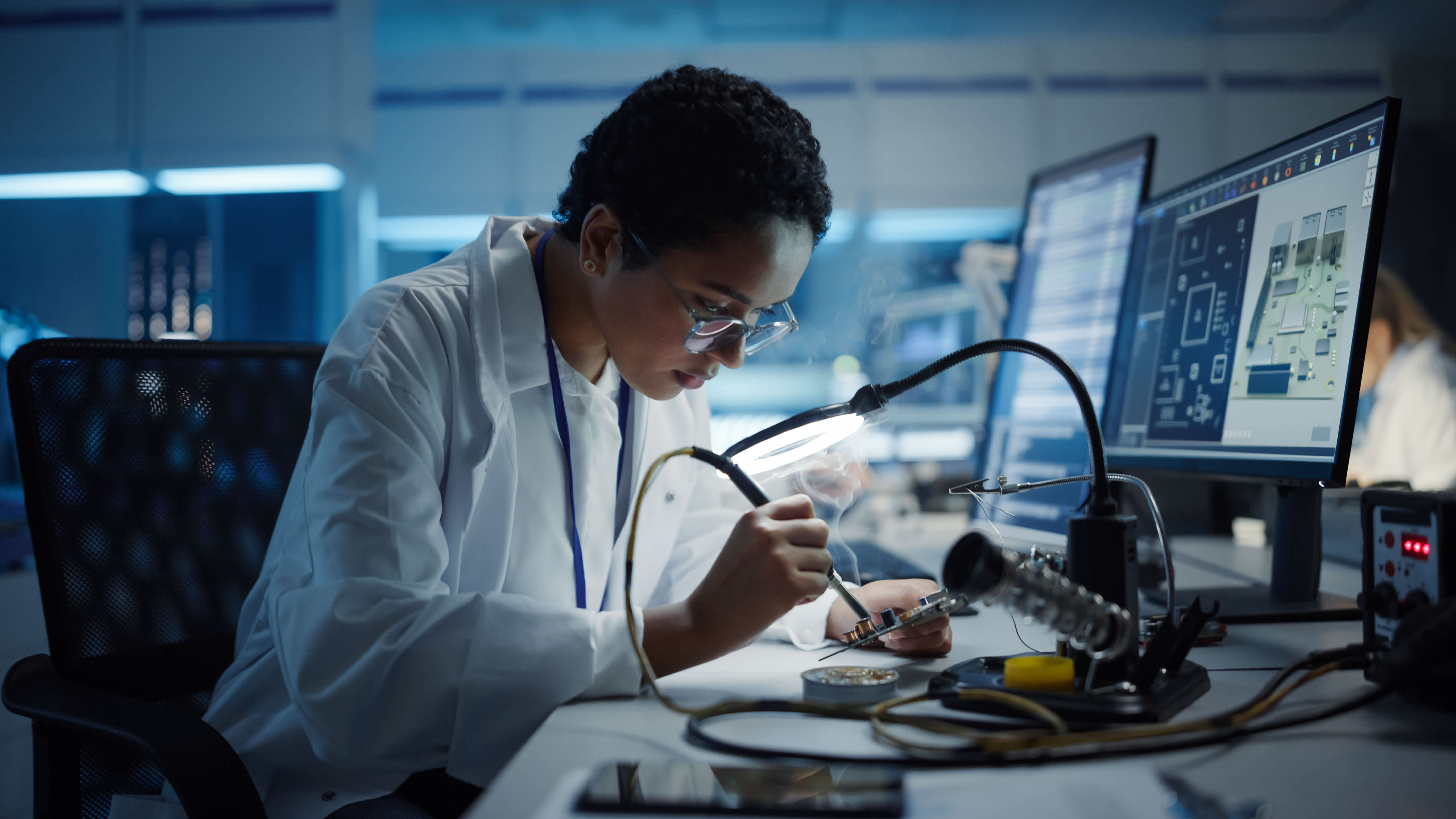 person soldering electronic components