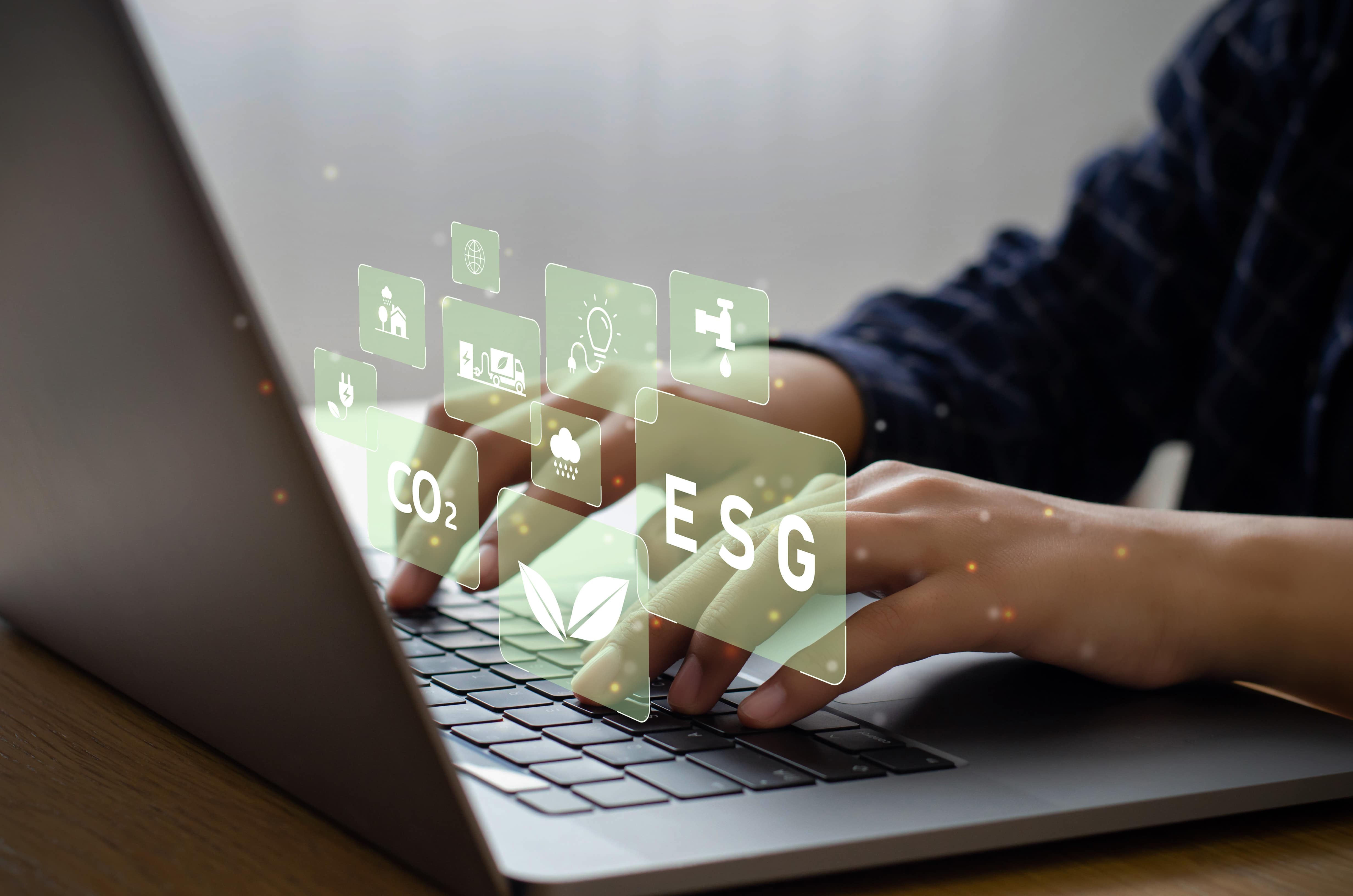 A person using a laptop, with icons representing ESG, fossil fuels, renewable energy and other environmentally friendly sources.