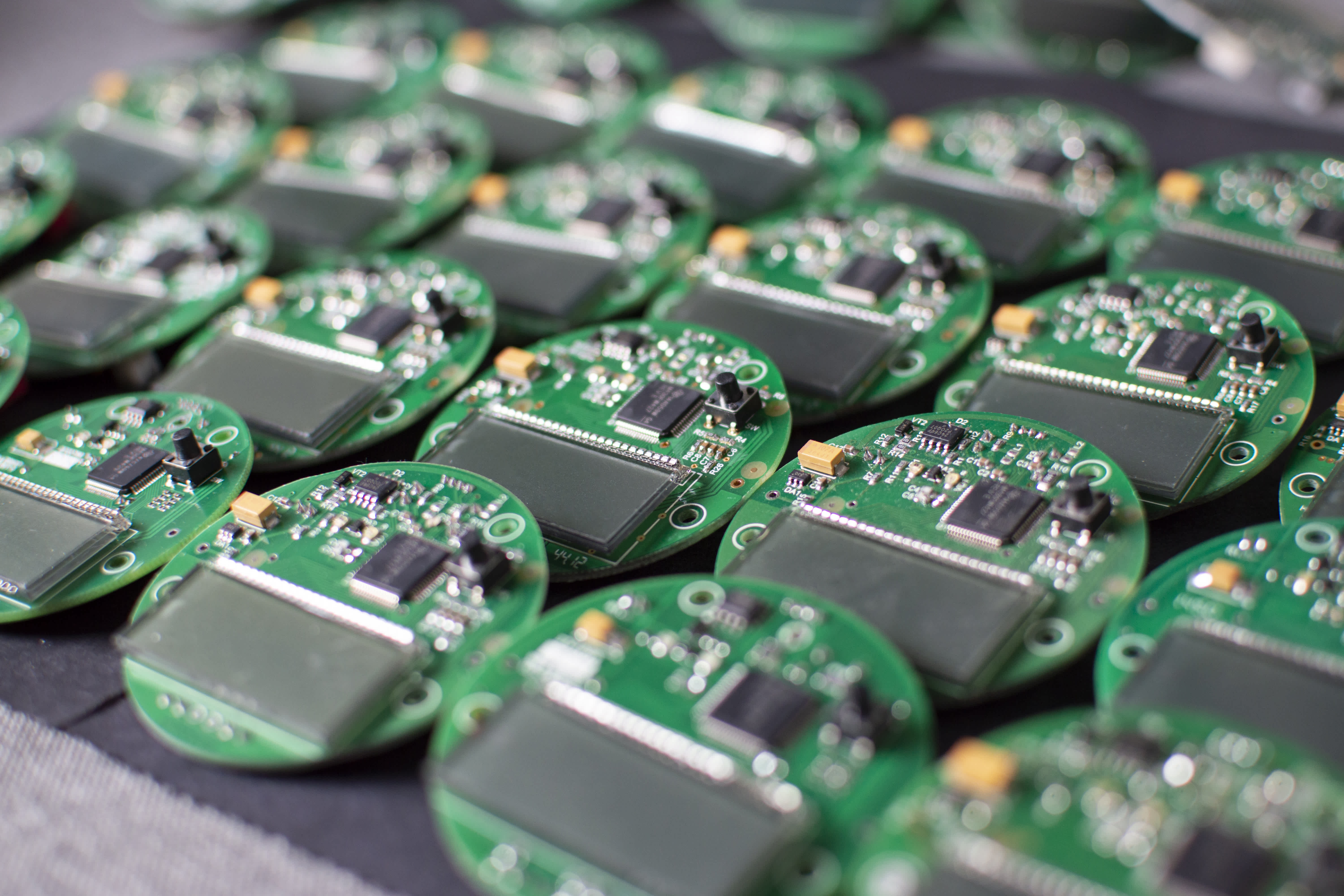 Rows of printed circuit boards on an assembly line.