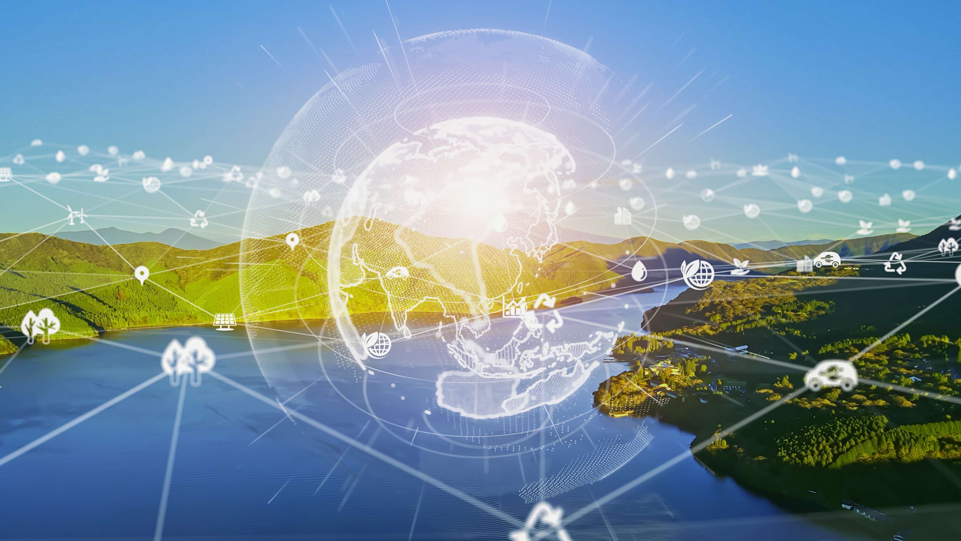 An illustration of a digital globe, surrounded by ESG related icons overlaying a countryside background with green hills and a bright blue river.