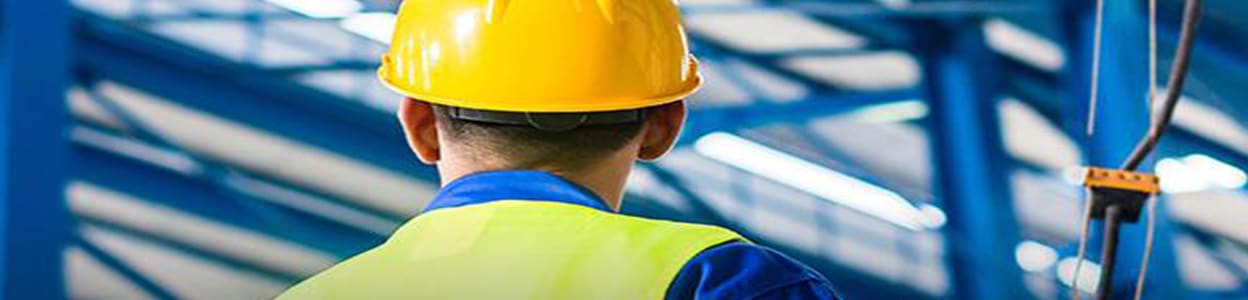 man in a hard hat assessing a building