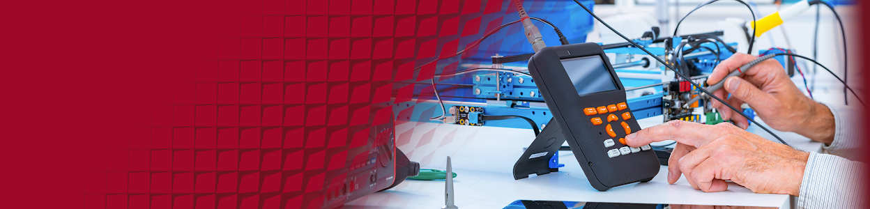 Engineer using a handheld oscilloscope to test and troubleshoot electronic circuits in a modern electronics lab.