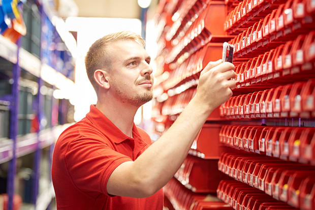 RS ScanStock representative scanning stock with red racking and storage bins